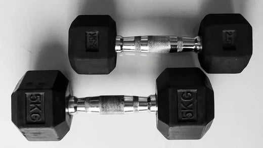 Pair of 5kg black hex dumbbells on a white background, ideal for home gym equipment and muscle building workouts.